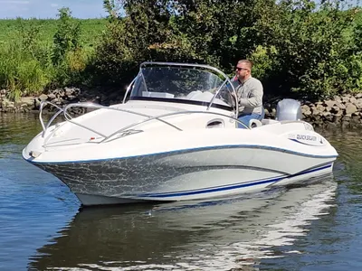 witte consoleboot op rivier met bestuurder