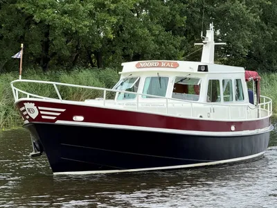 rood-witte motorboot op water bij riet