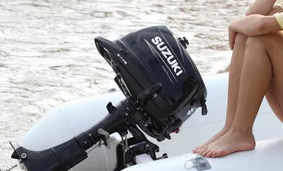 vrouw zit op opblaasboot met buitenboordmotor