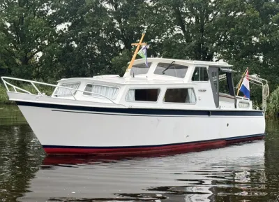 motorjacht op rustig water bij bomen