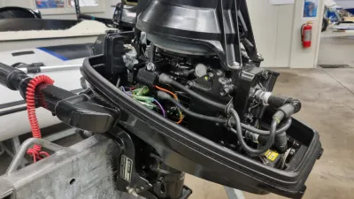 buitenboordmotor met geopende kap in werkplaats