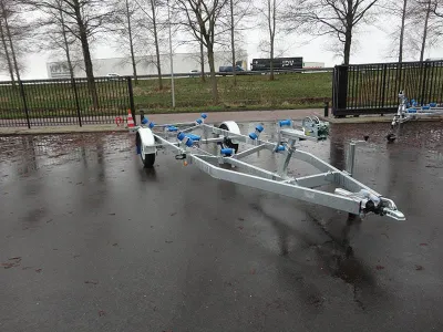 boottrailer op natte parkeerplaats bij hek