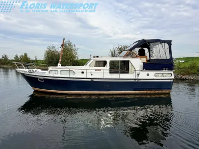 motorjacht in rustig water bij oever