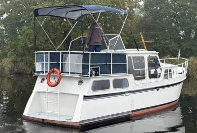 witte motorkruiser afgemeerd op water